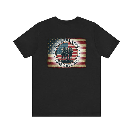 Unisex USA Some Gave All Tee, black shirt with flag and soldiers print. Airlume cotton, ribbed collar, retail fit. Sizes XS-3XL. Reflects 'Worlds Worst Tees' store ethos.