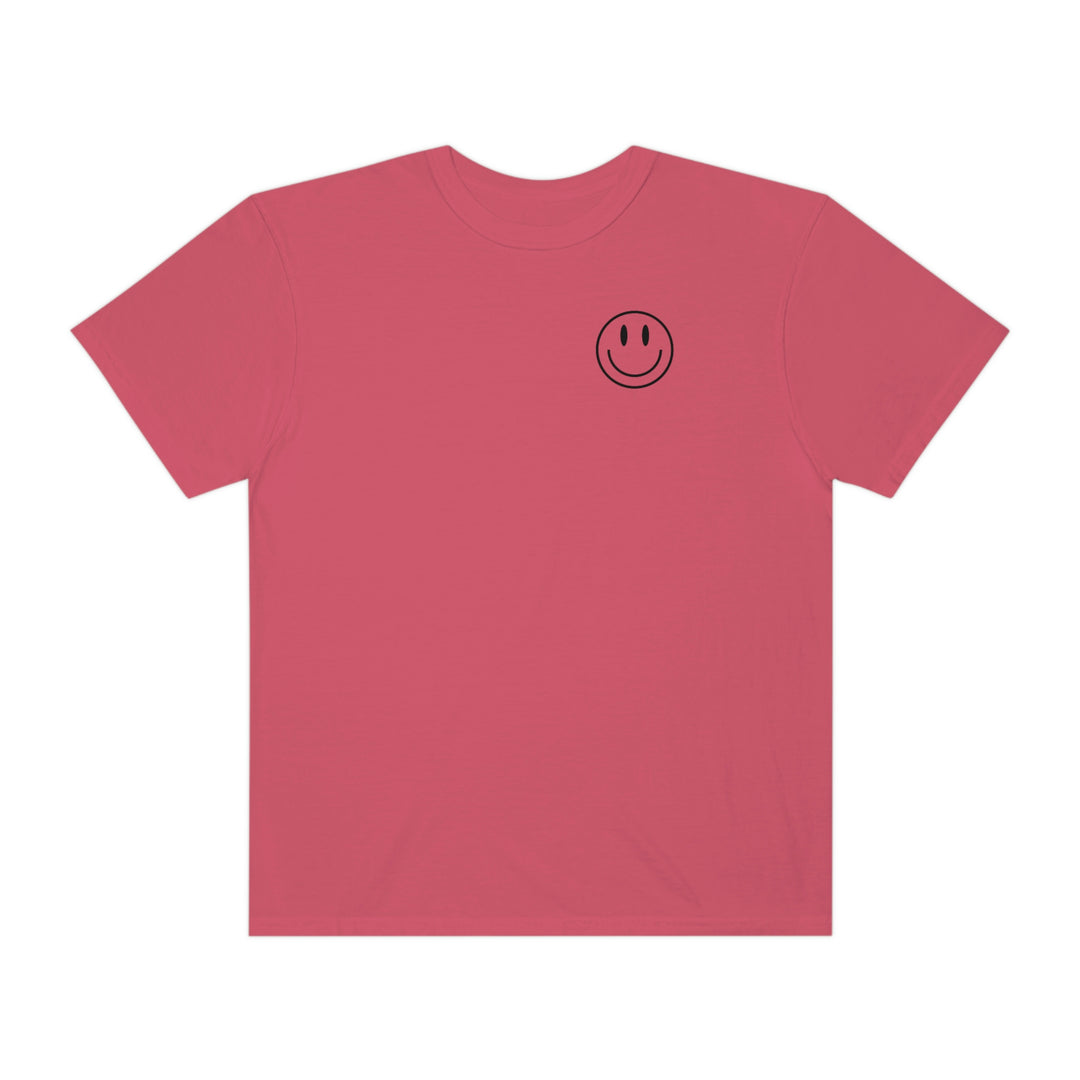 A relaxed fit, garment-dyed tee made of 100% ring-spun cotton, featuring a smiley face graphic. Durable double-needle stitching with a tubular shape for extra coziness. From 'Worlds Worst Tees'.