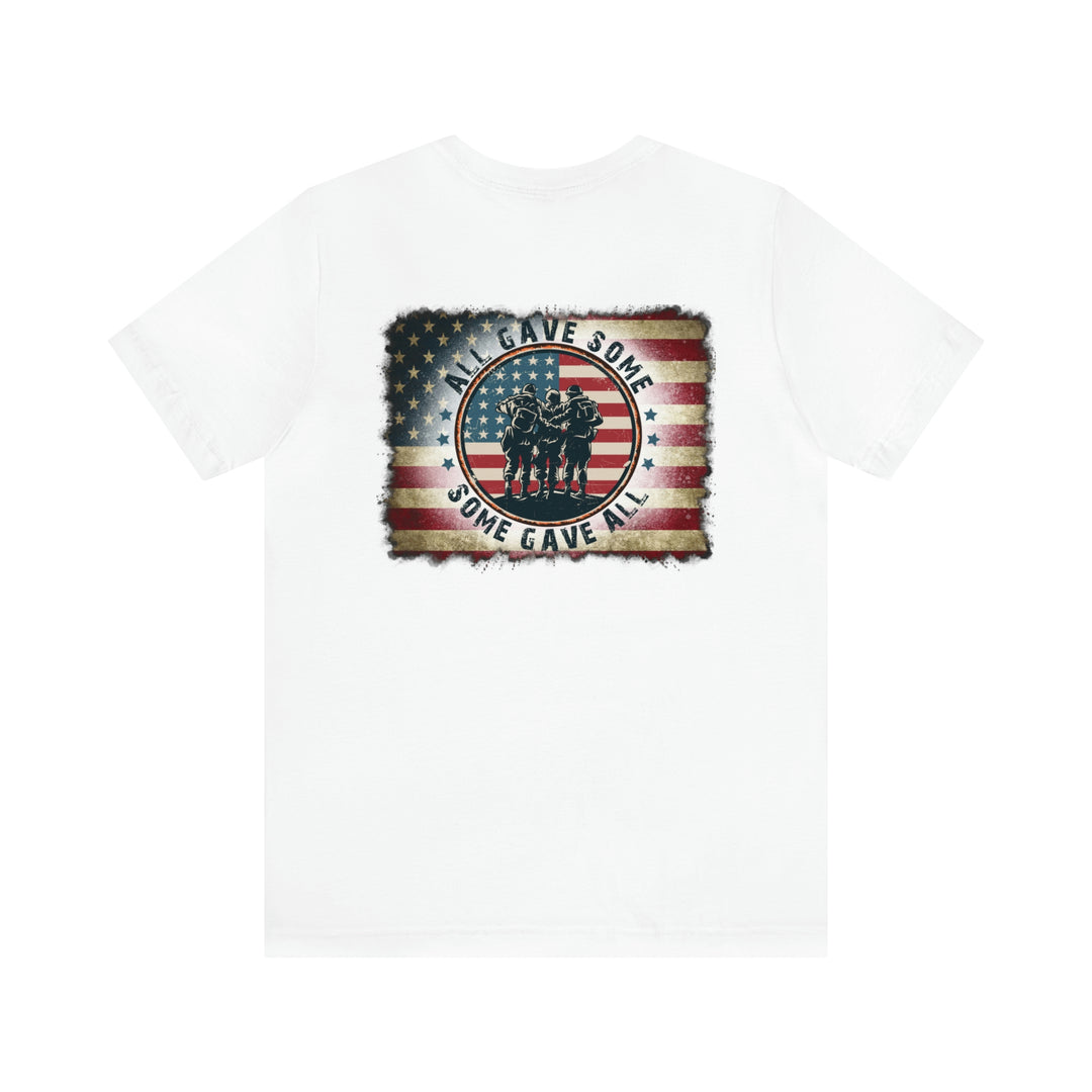 A white t-shirt featuring a flag and soldiers, embodying patriotism and remembrance. Unisex jersey tee with ribbed knit collars, taping for fit, and Airlume combed cotton for comfort.