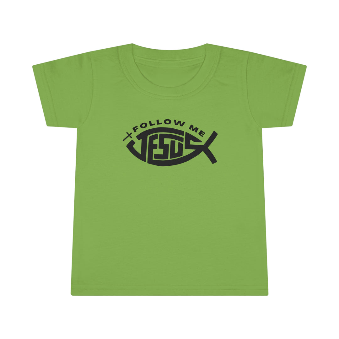 A Jesus Follow Me Toddler Tee with a green shirt featuring a black design. Classic fit, 100% Ringspun cotton, durable double-needle stitching, and 3/4 collar. Ideal for active kids.