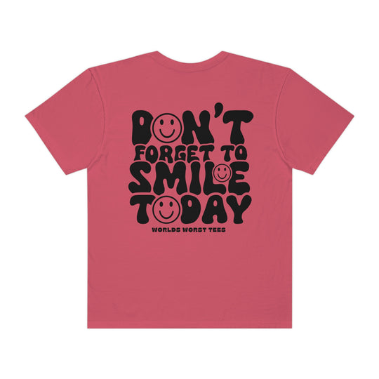 A relaxed-fit, garment-dyed tee made of 100% ring-spun cotton, featuring a pink shirt with black text and smiley faces. Durable double-needle stitching and seamless design for added comfort. From 'Worlds Worst Tees'.