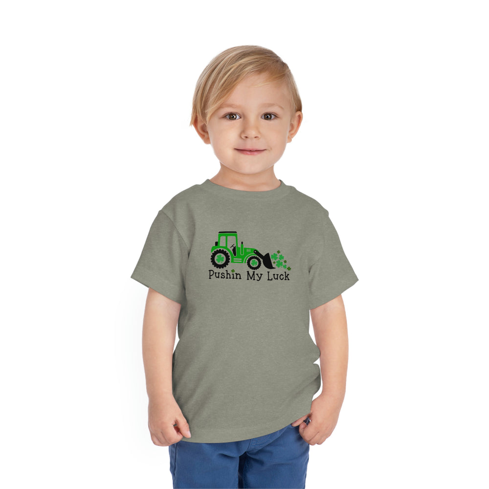 A custom Pushin My Luck Toddler Tee, featuring a child in a grey shirt, perfect for everyday wear. Made of 100% Airlume combed cotton, with short sleeves and tear-away label for comfort.