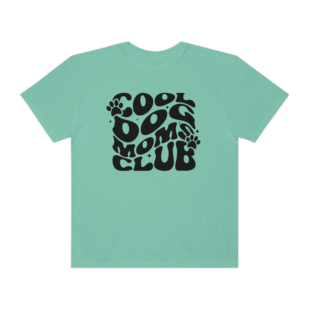 Cool Dog Mom's Club Tee: A relaxed-fit t-shirt with a black paw print logo on a blue background. Made of 100% ring-spun cotton, garment-dyed for extra coziness and durability. Ideal for daily wear.
