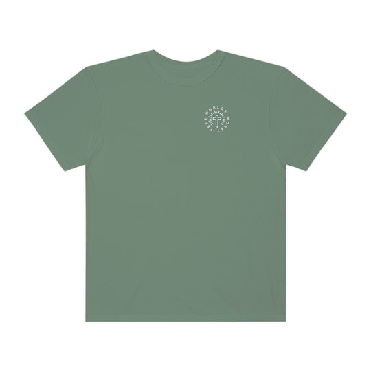 A Blessed Mom Tee: Green shirt with a cross logo. 100% ring-spun cotton, garment-dyed for coziness. Relaxed fit, durable double-needle stitching, no side-seams for tubular shape. Sizes: S-3XL.