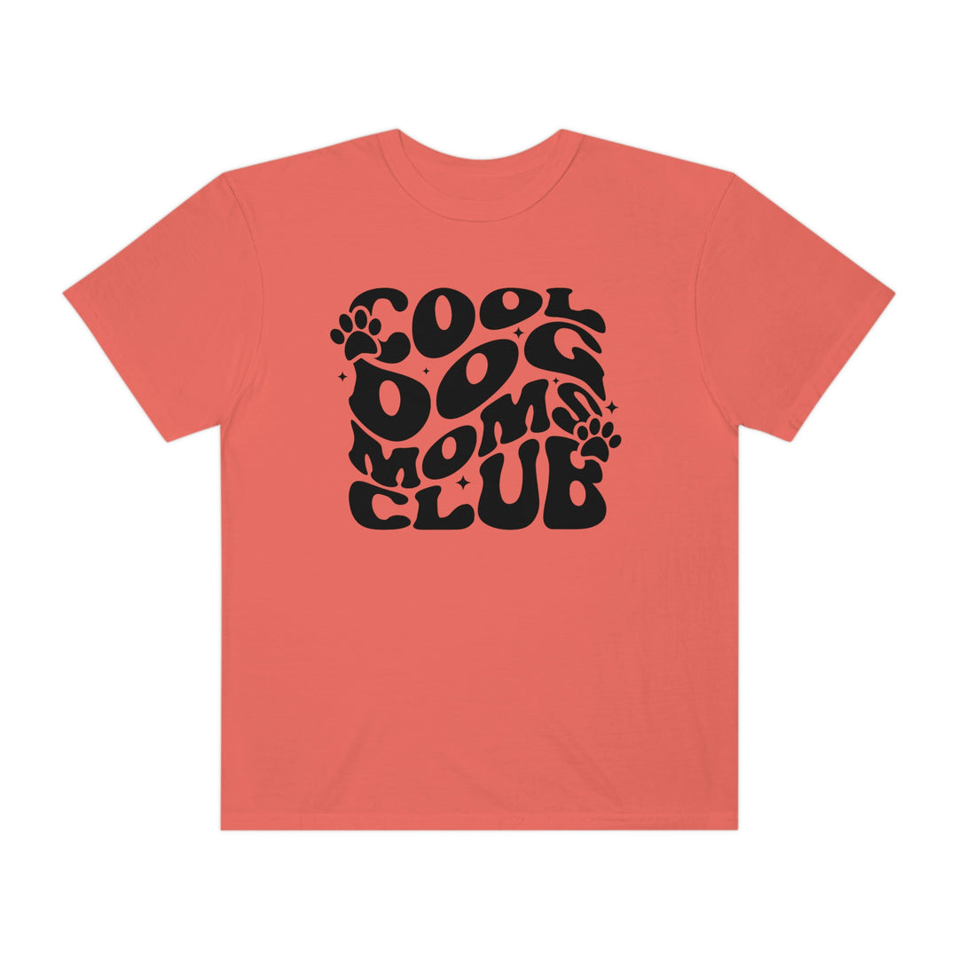 Cool Dog Mom's Club Tee: A black t-shirt featuring a paw print logo on a pink background. 100% ring-spun cotton, garment-dyed for extra coziness and durability. Relaxed fit with double-needle stitching.