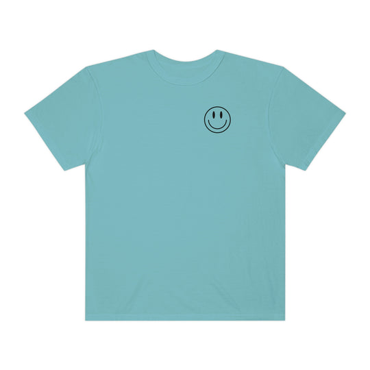 Blue t-shirt featuring a smiley face design, the Don't Forget To Smile Today Tee. Made of 100% ring-spun cotton, garment-dyed for extra softness, with a relaxed fit and durable double-needle stitching.