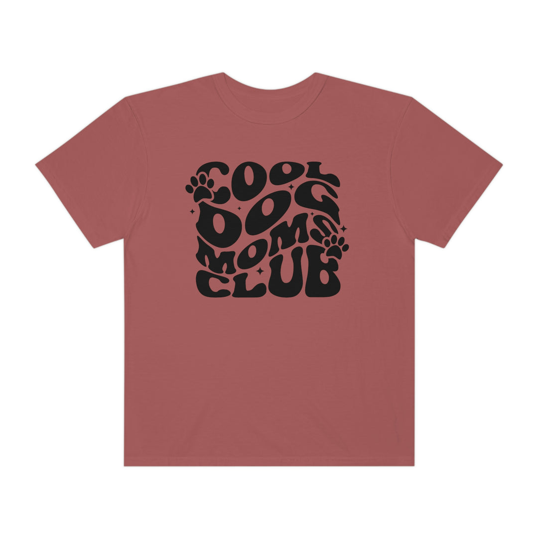 Cool Dog Mom's Club Tee: Red shirt with black text, featuring a paw print and circle design. 100% ring-spun cotton, garment-dyed for coziness, with double-needle stitching for durability and a relaxed fit.